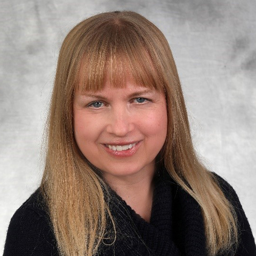 A woman with long blonde hair and bangs.