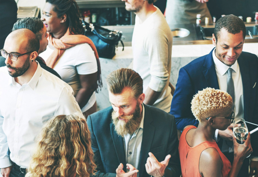 A group of people standing around each other.