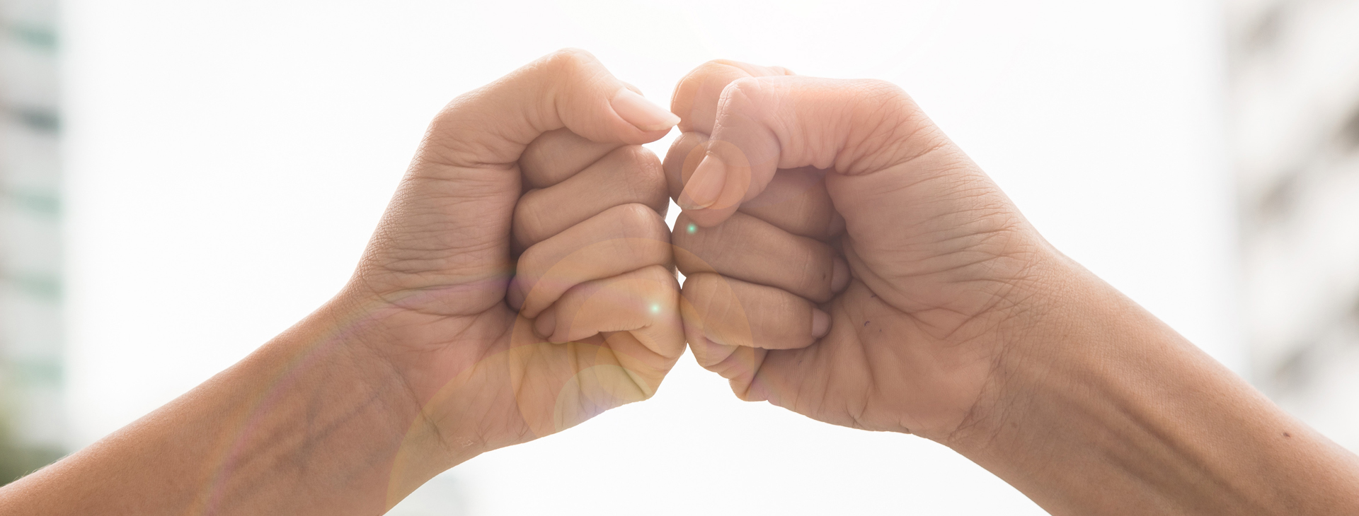 Two hands are holding each other in a fist.