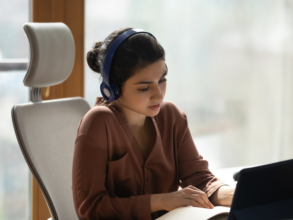 A woman sitting in front of a laptop computer.