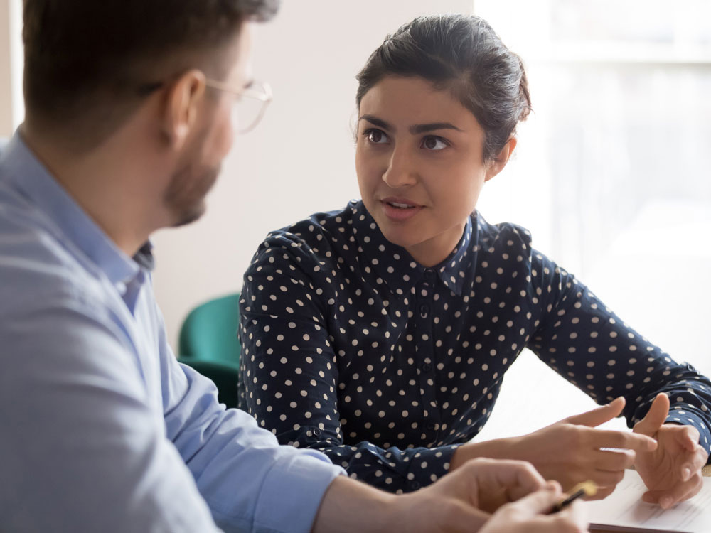 A woman and man are sitting at a table