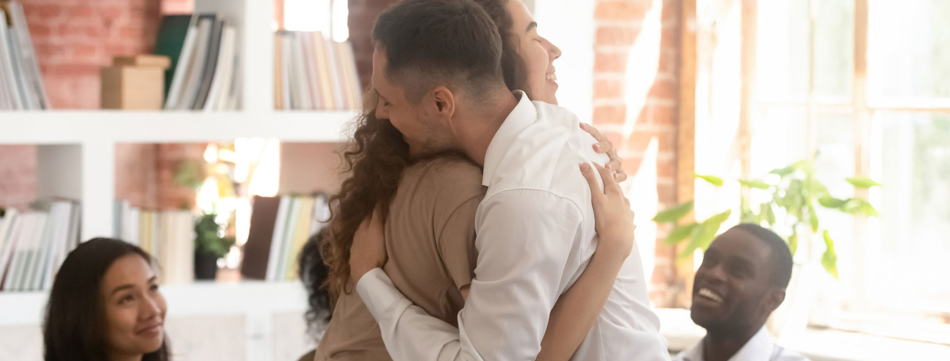 A man and woman hugging each other.