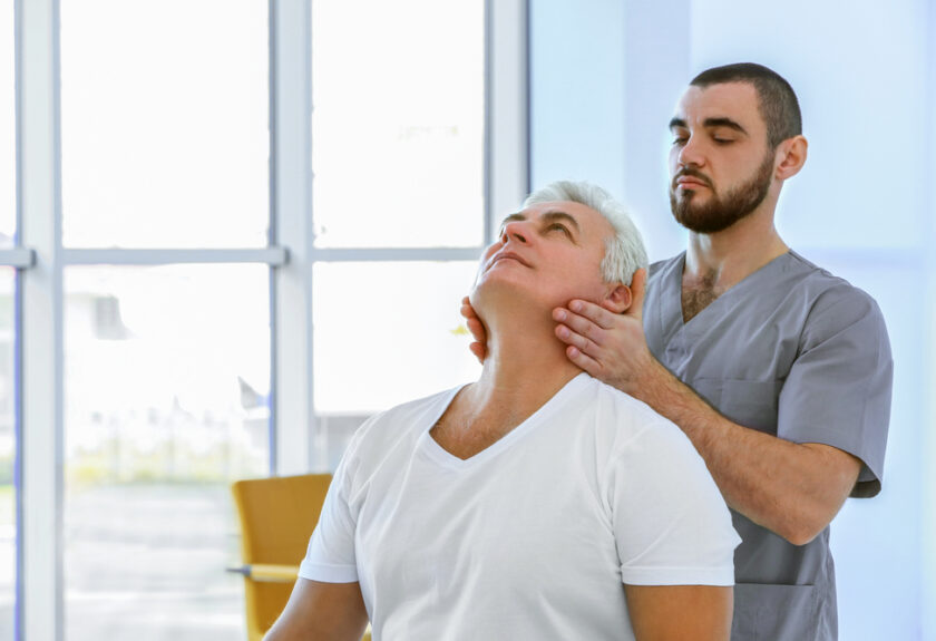 A man is doing an adjustment to his neck.