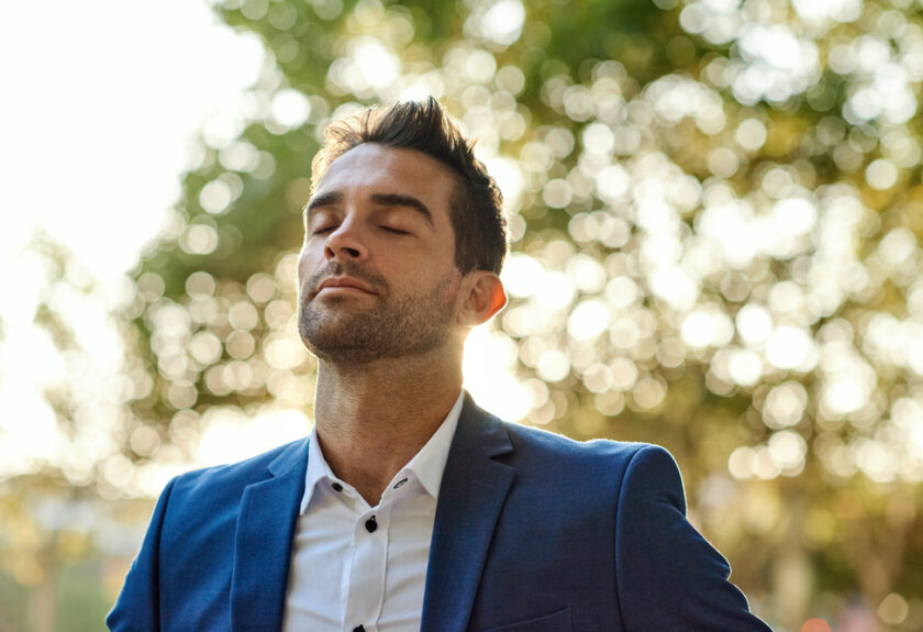 A man in a suit and tie looking up.