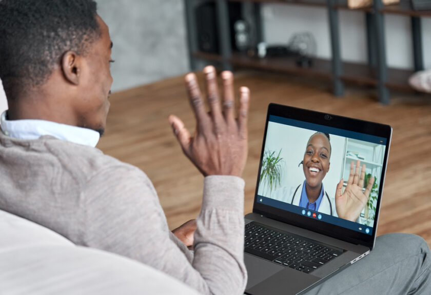 A man sitting in front of a laptop.