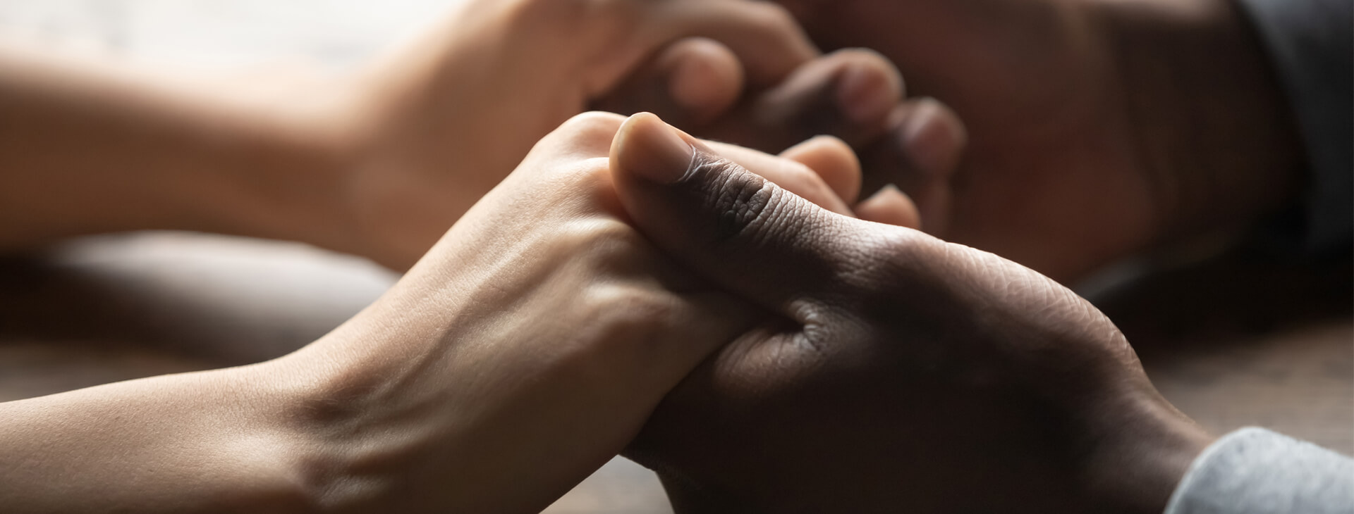 A close up of two hands holding each other