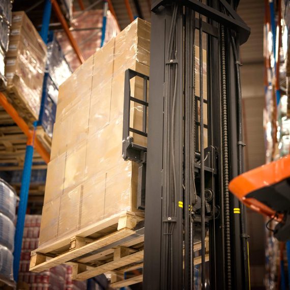 A warehouse with many items stacked on pallets.